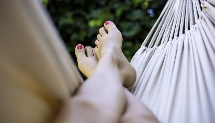 Vrouw met blote voeten in de hangmat 