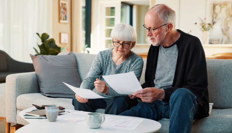 Man en vrouw kijken door papieren zorgverzekering