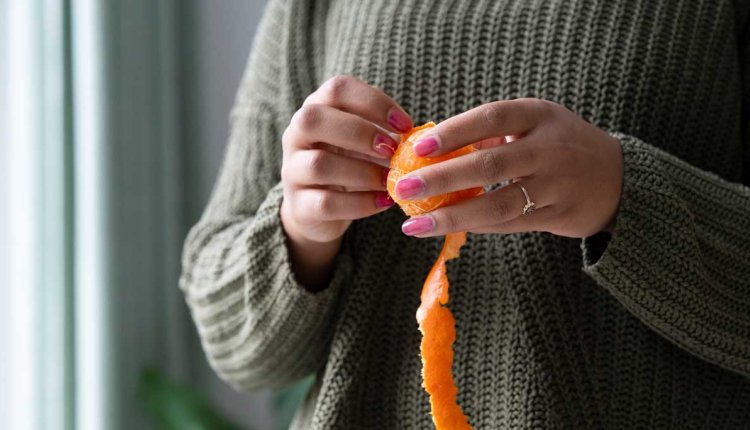 Vrouw pelt mandarijn