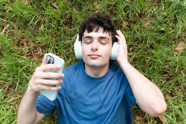 Man met koptelefoon in het park