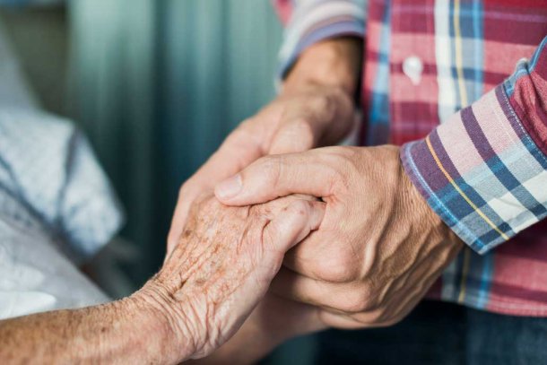 Zoon houdt hand vast van zijn moeder